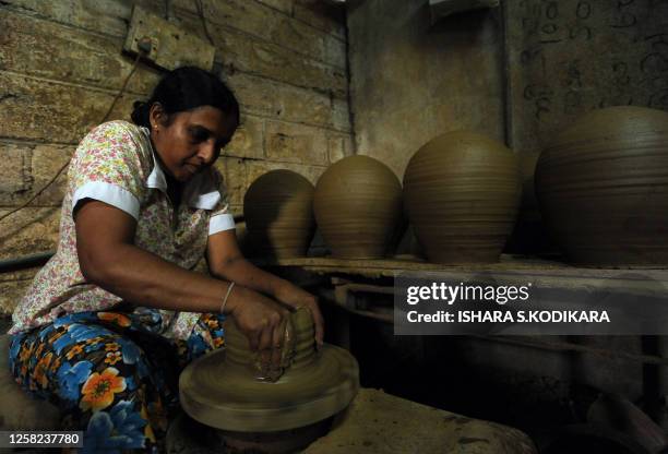Sri Lankan woman makes earthenware at a pottery factory in the Colombo suburb of Kaduwela on March 7, 2010. Sri Lanka marks International Women's Day...