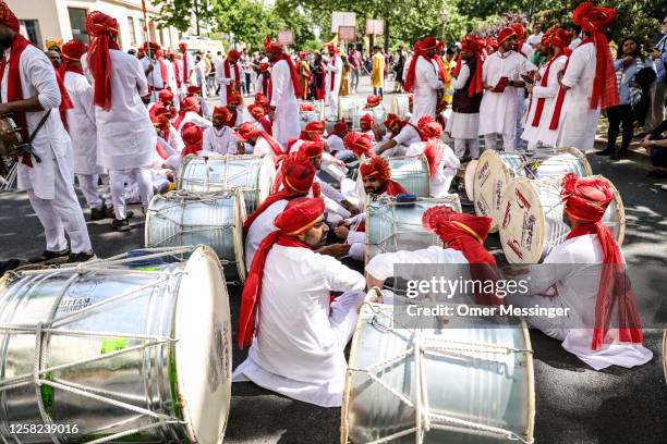 Drummers sit among their instruments in traditional Indian outfits, during the annual Carnival of Cultures parade on May 28, 2023 in Berlin, Germany....