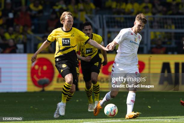 Julian Brandt of Borussia Dortmund and Anton Stach of 1. FSV Mainz 05 battle for the ball during the Bundesliga match between Borussia Dortmund and...