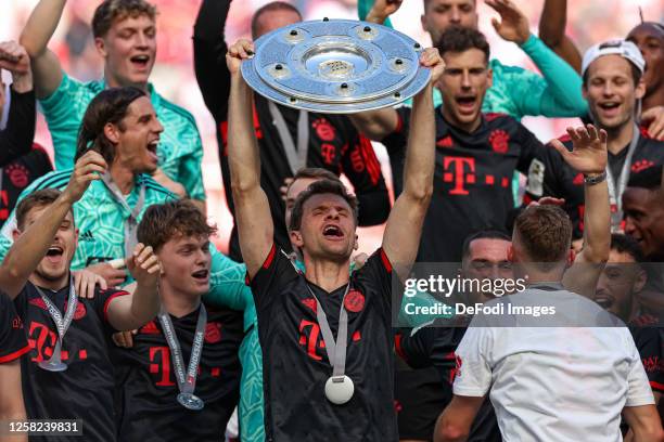 Thomas Mueller of Bayern Muenchen holds up the championship trophy after the Bundesliga match between 1. FC Köln and FC Bayern München at...