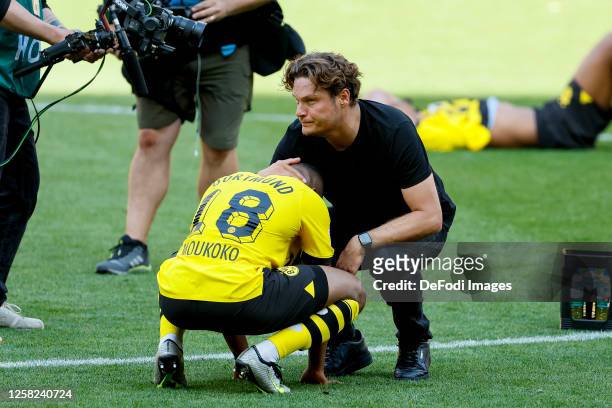 Edin Terzic Head Coach of Borussia Dortmund and Niklas Suele of Borussia Dortmund look disappointed and comfort each other after the Bundesliga match...