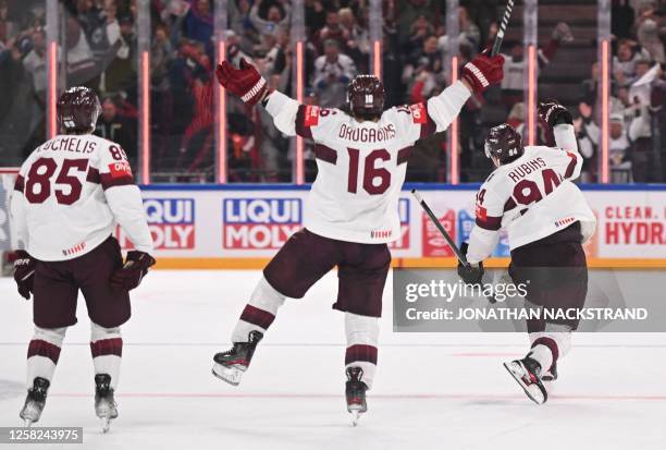 Latvia's defender Kristians Rubins celebrates his 3-4 during the IIHF Ice Hockey Men's World Championships third place play-off match betweeen United...