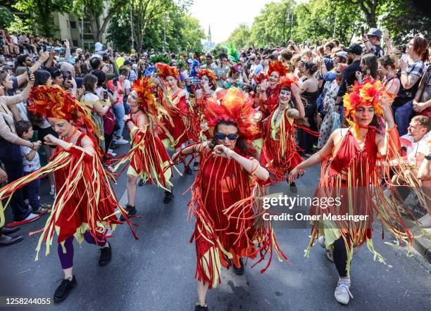 Dancers in colorful outfits dance through the crowd, during the annual Carnival of Cultures parade on May 28, 2023 in Berlin, Germany. The parade,...
