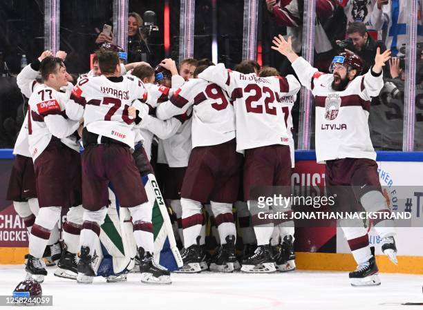 Latvia's team celebrates winning the IIHF Ice Hockey Men's World Championships third place play-off match betweeen United States and Latvia in...