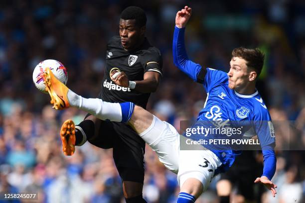 Bournemouth's Burkinabe striker Dango Ouattara challenges Everton's English midfielder James Garner during the English Premier League football match...