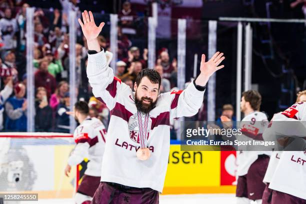 Kaspars Daugavins of Latvia celebrates the bronze medal during the 2023 IIHF Ice Hockey World Championship Finland - Latvia game between USA and...