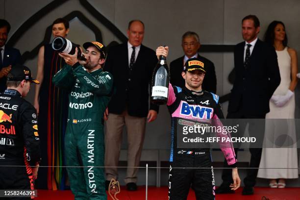 Second-placed Aston Martin's Spanish driver Fernando Alonso and third-placed Alpine's French driver Esteban Ocon celebrate on the podium after the...