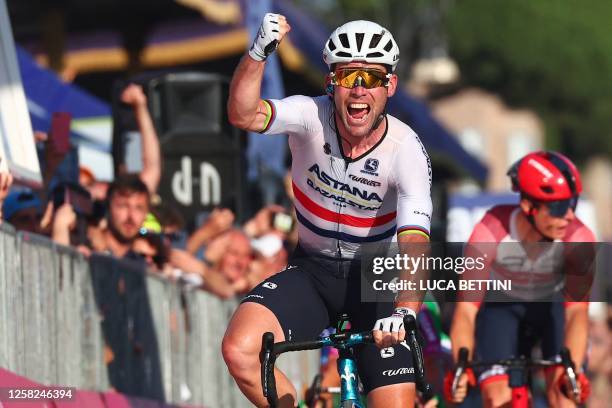 Astana Qazaqstan Team's British rider Mark Cavendish celebrates as he crosses the finish line to win the twenty-first and last stage of the Giro...