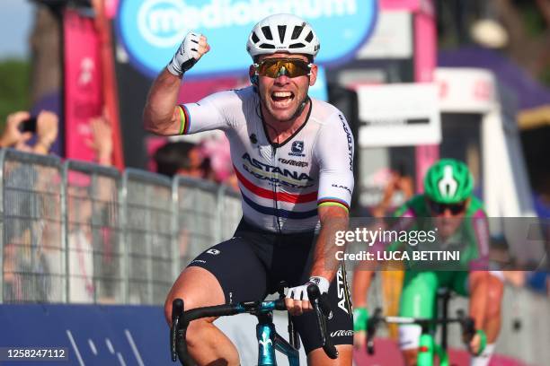 Astana Qazaqstan Team's British rider Mark Cavendish celebrates as he crosses the finish line to win the twenty-first and last stage of the Giro...