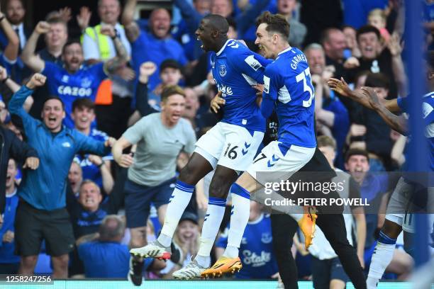 Everton's French midfielder Abdoulaye Doucoure celebrates with teammates after scoring a goal during the English Premier League football match...