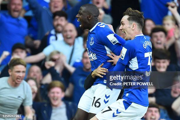 Everton's French midfielder Abdoulaye Doucoure celebrates with Everton's English midfielder James Garner after scoring the opening goal during the...