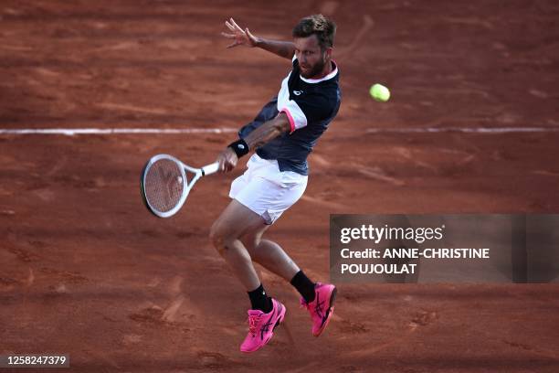 France's Corentin Moutet plays a sliced return to France's Arthur Cazaux during their men's singles match on day one of the Roland-Garros Open tennis...