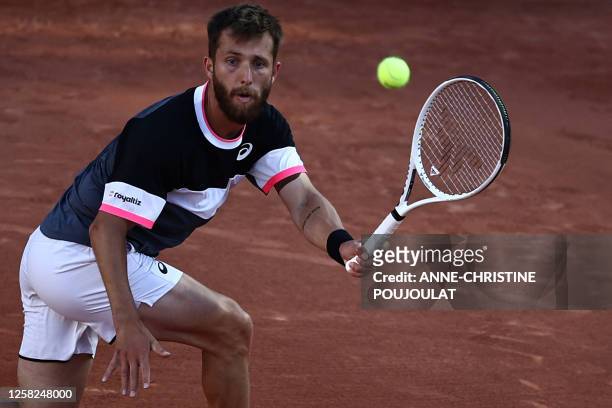 France's Corentin Moutet plays a forehand return to France's Arthur Cazaux during their men's singles match on day one of the Roland-Garros Open...