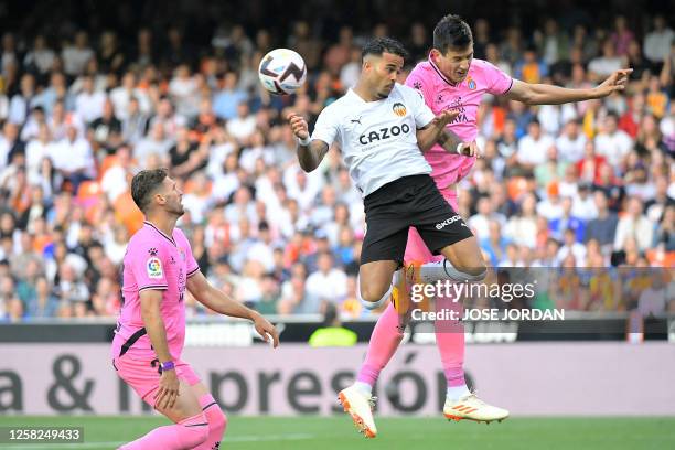 Espanyol's Mexican defender Cesar Montes and Valencia's Dutch forward Justin Kluivert vie for a header during the Spanish league football match...