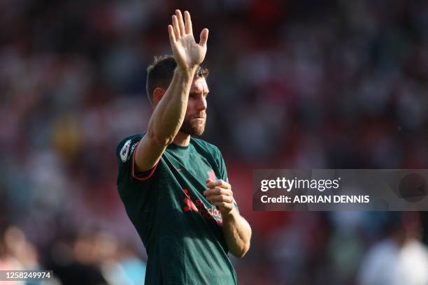 Liverpool's English midfielder James Milner waves to supporters on the pitch after the English Premier League football match between Southampton and...