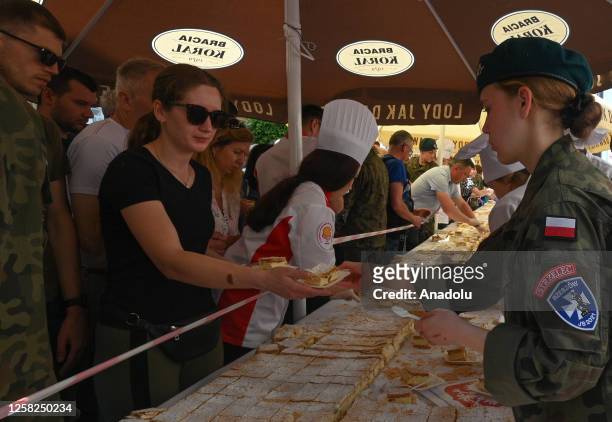 Distribution of the 103-metre 'Papal Kremowka' cake divided into 14,000 portions outside the church of St. Cross in Rzeszow, Poland, on May 27, 2023....