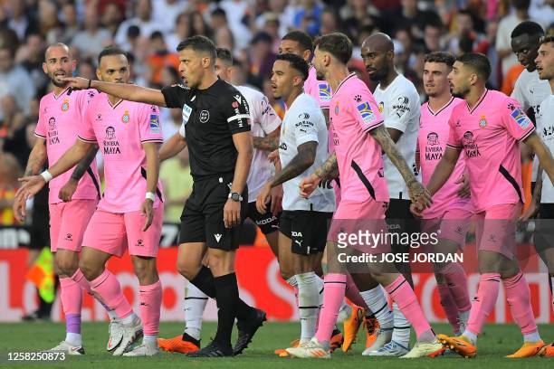 Spanish referee Gil Manzano gestures during the Spanish league football match between Valencia CF and RCD Espanyol at the Mestalla stadium in...