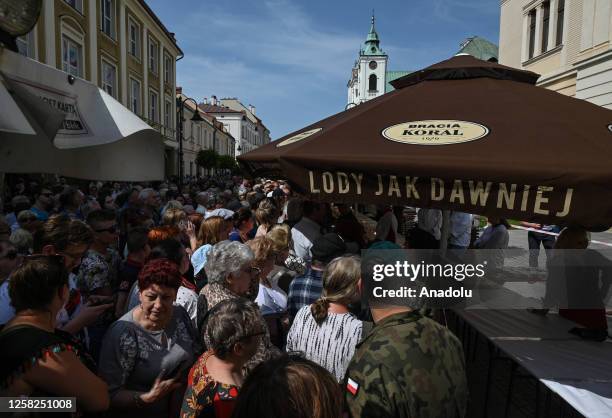 People attending the distribution of 103-metre 'Papal Kremowka' cake divided into 14,000 portions outside the church of St. Cross in Rzeszow, Poland,...