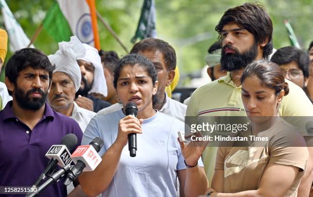 Wrestlers Vinesh Phogat, Sakshi Malik and Bajrang Punia speak with the media during their protest against Wrestling Federation of India chief Brij...