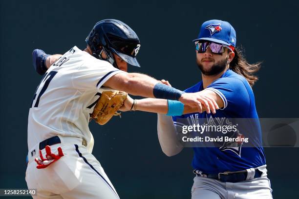 Bo Bichette of the Toronto Blue Jays tags out Edouard Julien of the Minnesota Twins in the first inning at Target Field on May 28, 2023 in...