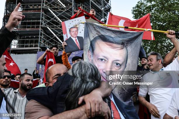 Local Turkish people celebrate along the Kurfürstendamm avenue, the preliminary results in Turkey's general election run-off that indicate a win for...