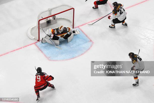 Canada's forward Samuel Blais shoots to score the 1-1 goal past Germany's goalkeeper Mathias Niederberger during the IIHF Ice Hockey Men's World...