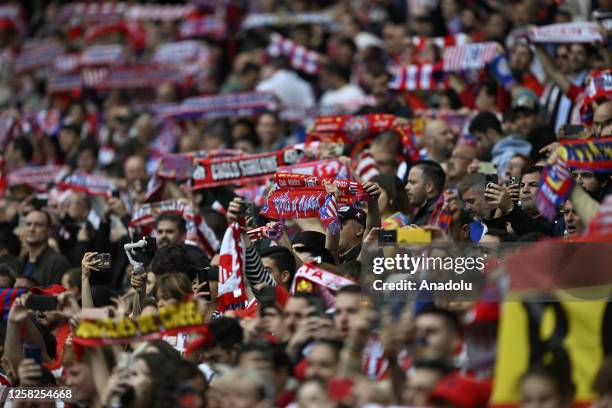 Fans of Atletico Madrid cheer at tribune during La Liga week 37 soccer match between Atletico Madrid and Real Sociedad at Civitas Metropolitano...