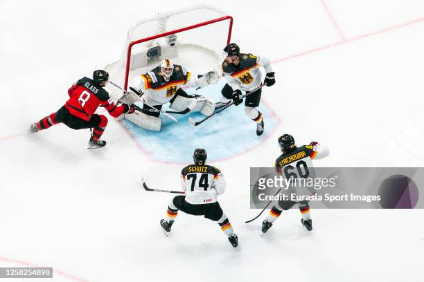 Cody Glass of Canada try to beat Mathias Niederberger of Germany during the 2023 IIHF Ice Hockey World Championship Finland - Latvia game between...