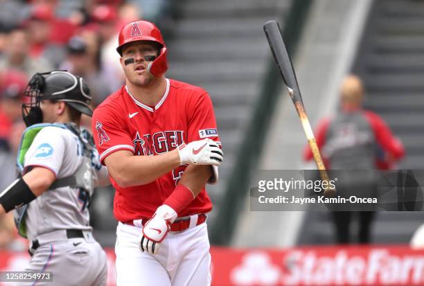 Mike Trout of the Los Angeles Angels tosses his bat after striking out to end the third inning against the Miami Marlins at Angel Stadium of Anaheim...