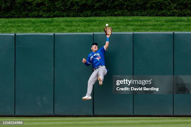 Daulton Varsho of the Toronto Blue Jays jumps to catch a fly ball hit by Carlos Correa of the Minnesota Twins for an out in the eighth inning at...