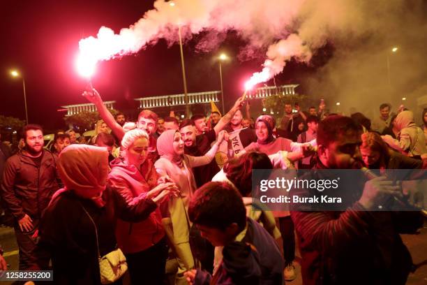 Supporters of Turkish President Recep Tayyip Erdogan celebrate as he claims victory in the Turkish presidential election runoff near the presidential...