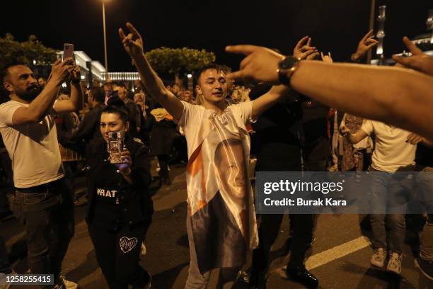 Supporters of Turkish President Recep Tayyip Erdogan celebrate as he claims victory in the Turkish presidential election runoff near the presidential...