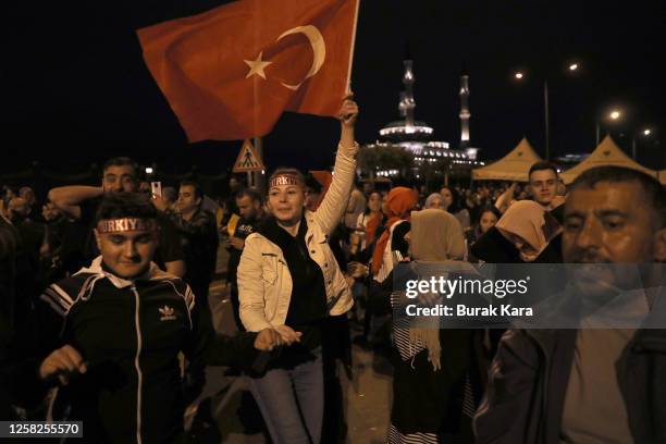 Supporters of Turkish President Recep Tayyip Erdogan celebrate as he claims victory in the Turkish presidential election runoff near the presidential...