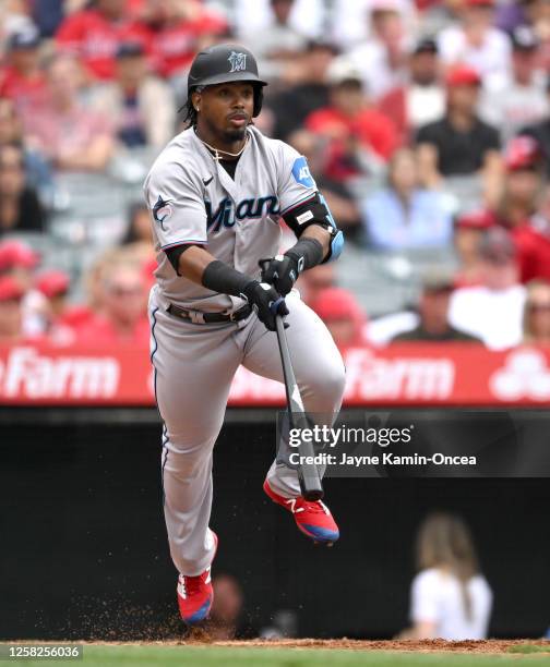 Jean Segura of the Miami Marlins jumps in the air and tosses his bat after hitting an RBI-single in the sixth inning against the Los Angeles Angels...
