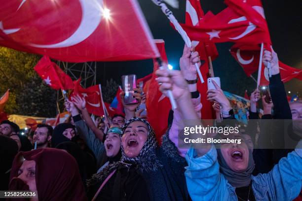 Supporters of Recep Tayyip Erdogan, Turkey's president and presidential candidate for the Justice and Development Party , celebrate in front of AKP...