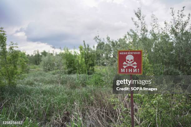 View of a warning sign for landmines in the recently occupied territory of Sviatohirsk. The ruined town of Sviatohirsk in Ukraine's Donbas Region....