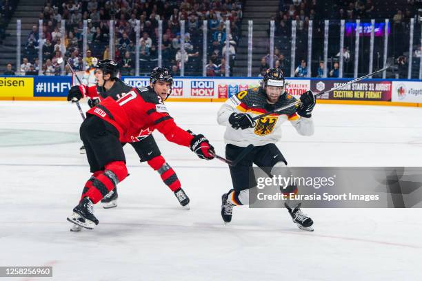 Wojciech Stachowiak of Germany overtake Justin Barron of Canada during the 2023 IIHF Ice Hockey World Championship Finland - Latvia game between...