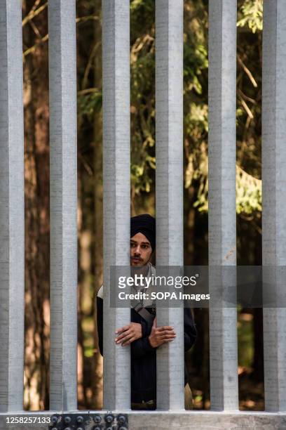 Migrant seeking asylum seen at the Belarusian side of the Polish border wall in Bialowieza. A group of 30 migrants and refugees from Iraq and Syria...