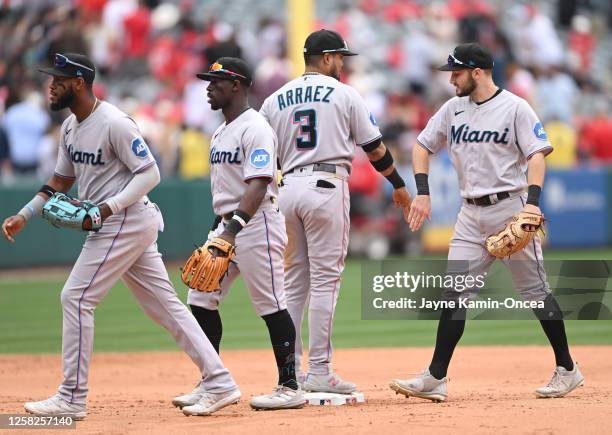 Bryan De La Cruz, Jonathan Davis, Luis Arraez and Garrett Hampson of the Miami Marlins head off the field after defeating the Los Angeles Angels at...