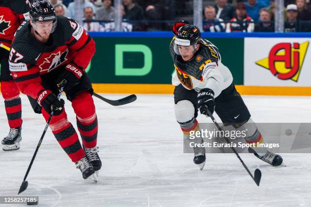 Tyler Myers of Canada chased by Daniel Fischbuch of Germany during the 2023 IIHF Ice Hockey World Championship Finland - Latvia game between Canada...