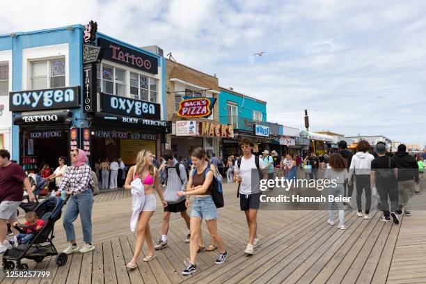 People spend time on the boardwalk during the Memorial Day weekend on May 28, 2023 in Wildwood, New Jersey. Memorial Day weekend kicks off the start...