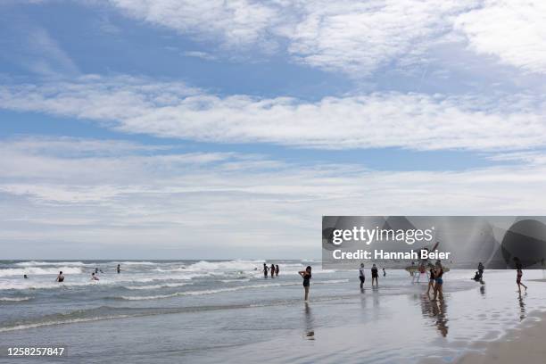 People spend time on the beach during the Memorial Day weekend on May 28, 2023 in Wildwood, New Jersey. Memorial Day weekend kicks off the start of...