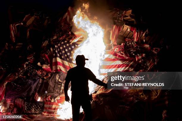 Volunteer helps light the Memorial Day Watchfire in Syracuse, New York, on May 28, 2023. It is said that after a battle, that there was an age-old...