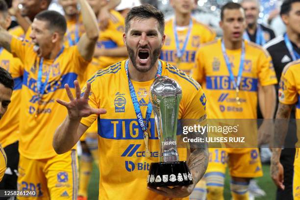 Tigres' French Andre-Pierre Gignac celebrates with the trophy after winning the Mexican Clausura football tournament by defeating Guadalajara 3-2 in...