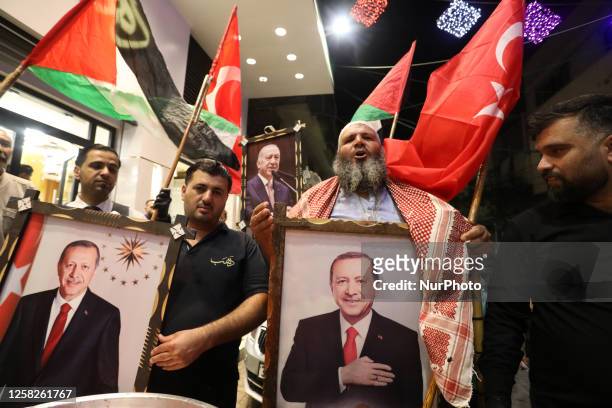 Palestinian supporters of Turkish President Tayyip Erdogan celebrate after early exit poll results in Turkey's presidential election, in Khan Younis...