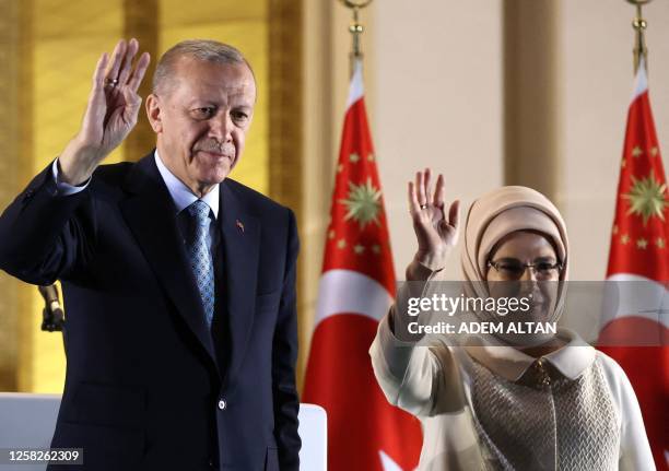 Turkish President Tayyip Erdogan and his wife Ermine Erdogan wave to his supporters following his victory in the second round of the presidential...