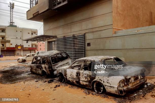 Destroyed vehicles are pictured outside the burnt-down headquarters of Sudan's Central Bureau of Statistics, on al-Sittin road in the south of...