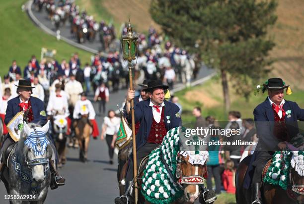 May 2023, Bavaria, Bad Kötzting: Participants of the Kötztinger Pfingstritt ride with their horses on a road. The procession is one of the oldest...