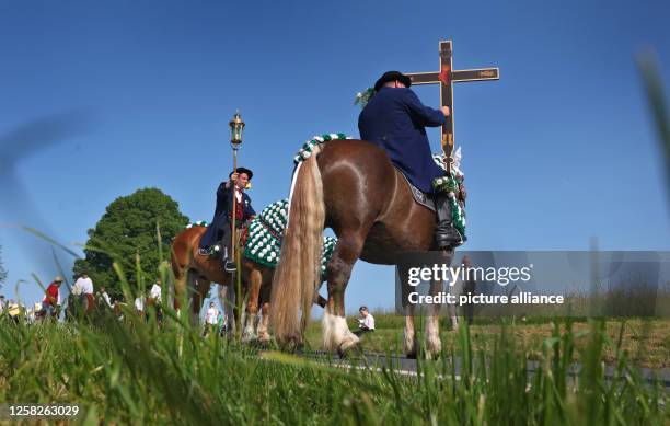 May 2023, Bavaria, Bad Kötzting: Participants of the Kötztinger Pfingstritt ride with their horses on a road. The procession is one of the oldest...