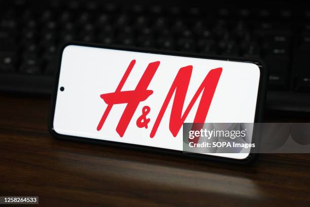 In this photo illustration, the H&M Hennes&Mauritz logo is displayed on the screen of a smartphone.